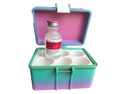 Open 6-slot BAC Water case showing six precision-fit white compartments and one displayed Hospira vial. The interior lid is pink with a clean, pastel-toned design—ideal for home storage or travel kits.