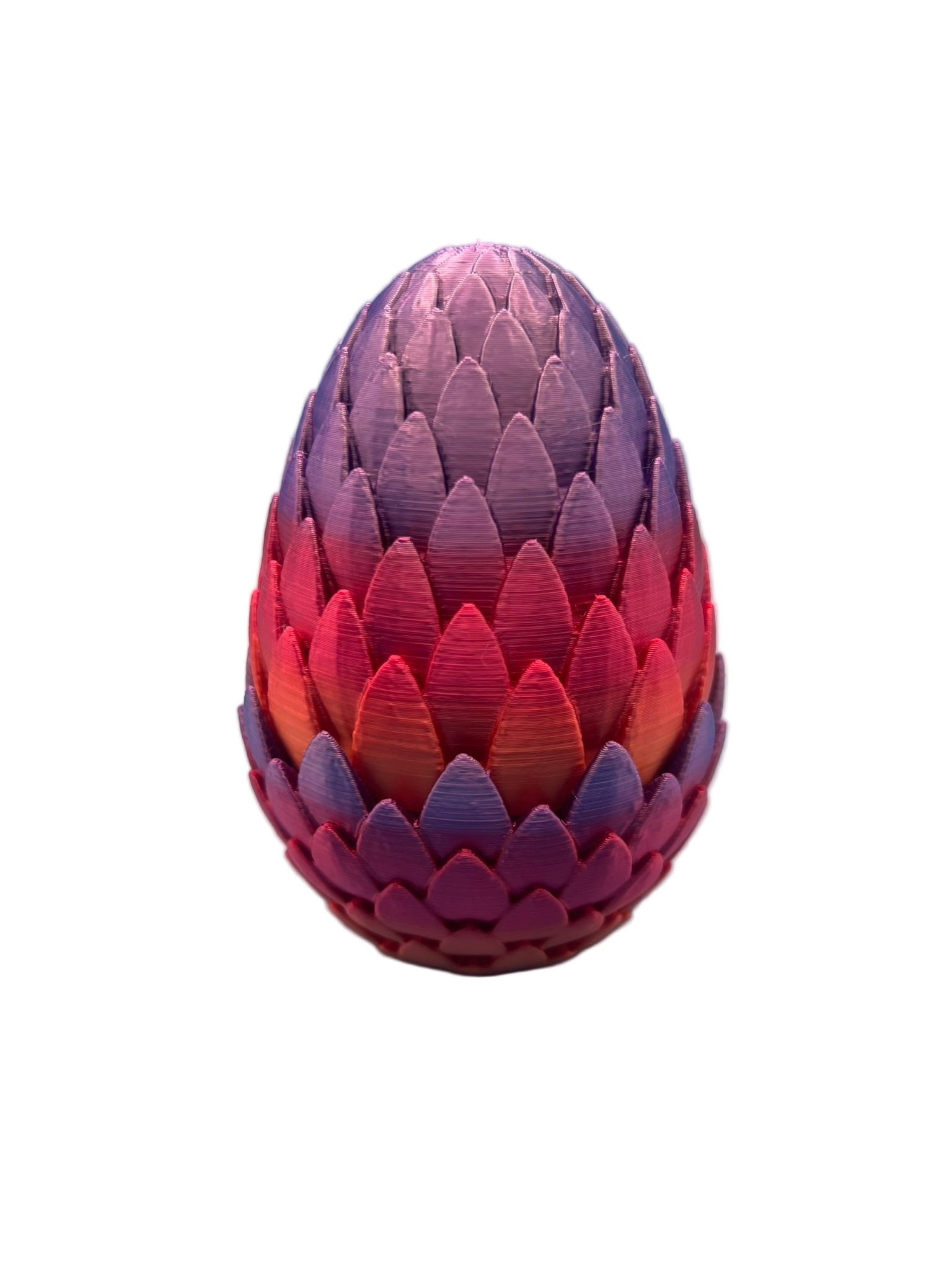 Closed dragon egg-style cartridge holder in a gradient of purple, pink, and orange, showing the detailed scale texture of the interlocking outer shell.