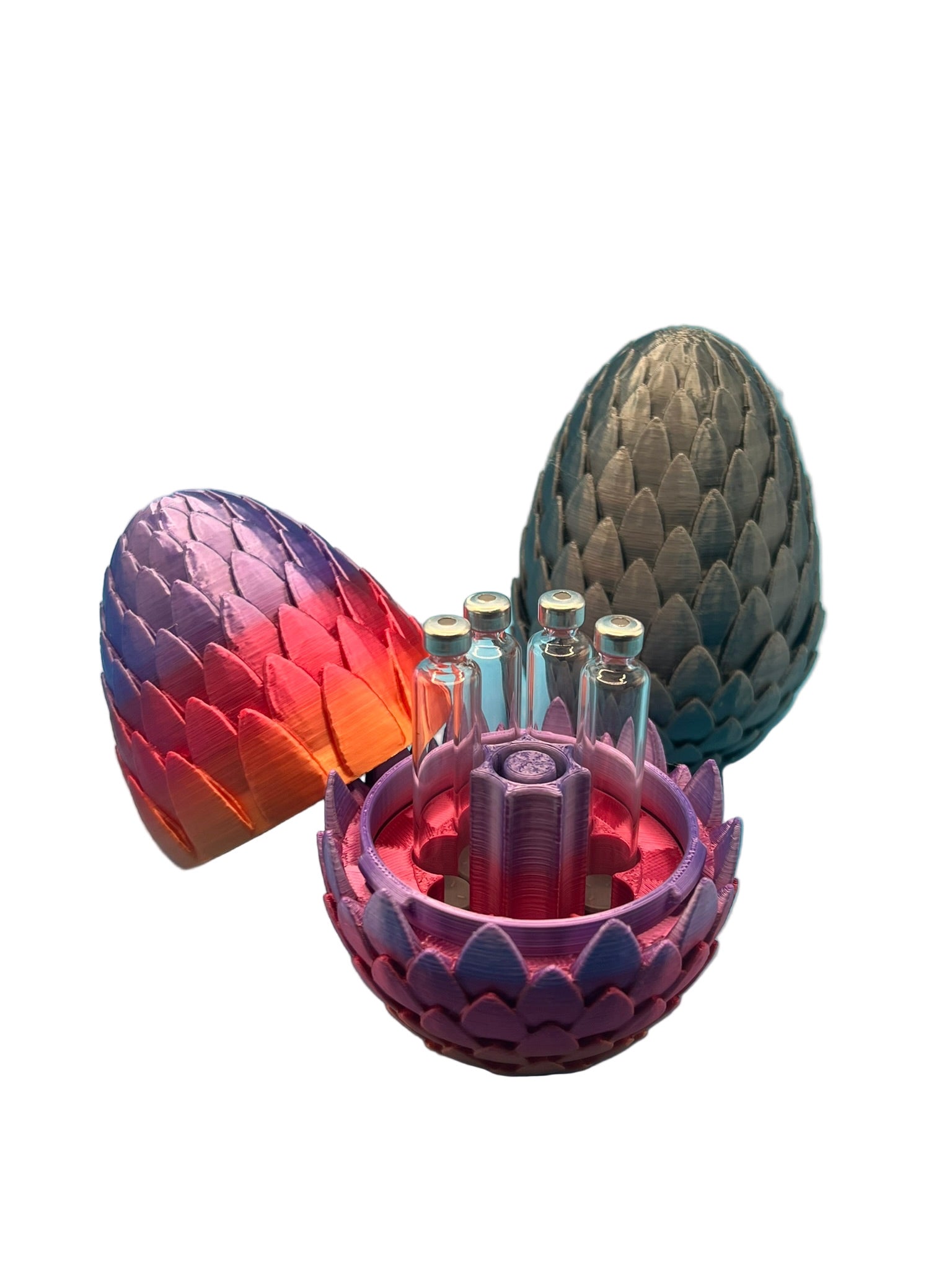 Dragon egg-style cartridge holders in multiple colors, with one open to display seven 3ml glass cartridges arranged around a central purge tower.