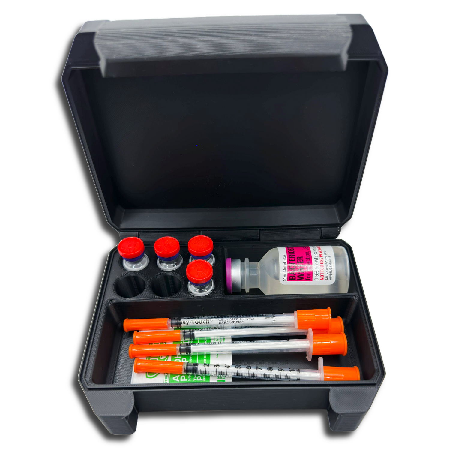Black snap-lock storage case holding six 3ml vials, a large vial, syringes, and alcohol prep pads – organized medical supply storage