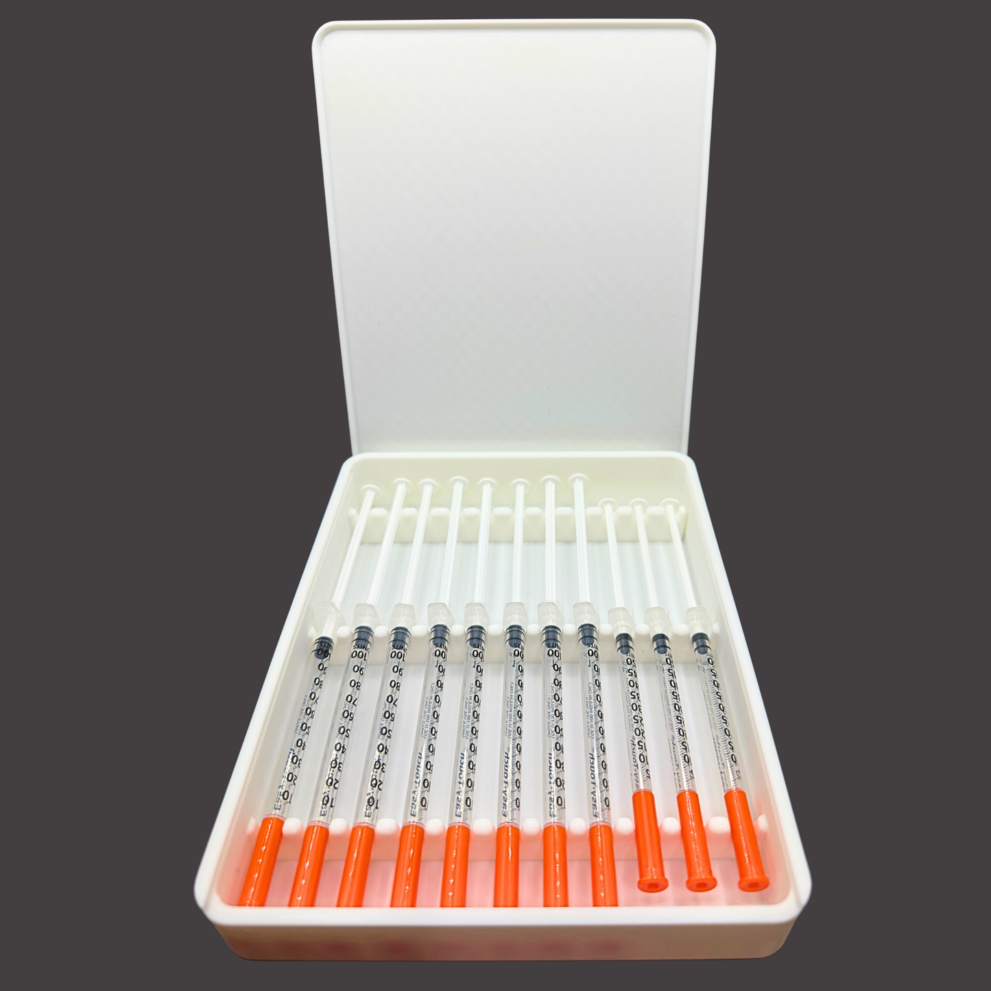 Open 11 slot prefilled syringe storage case showing eleven 1ml syringes neatly organized in individual channels. Slim rectangular syringe organizer designed for TRT, GLP-1, insulin, and general wellness routines. Interior layout keeps syringes separated, aligned, and secure to prevent shifting. Low-profile design fits easily in refrigerators, drawers, or travel bags. Syringes shown for demonstration only, storage case only.
