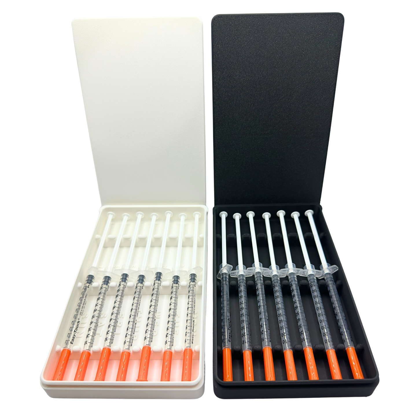 Two 7-slot weekly prefilled syringe storage cases shown side by side in white and black, both loaded with seven 1ml insulin syringes with orange caps. Sliding lid organizer with numbered slots and day-of-week labels Monday through Sunday. Available in two colors for TRT, GLP-1, insulin, HRT, or peptide weekly dose prep and fridge storage.