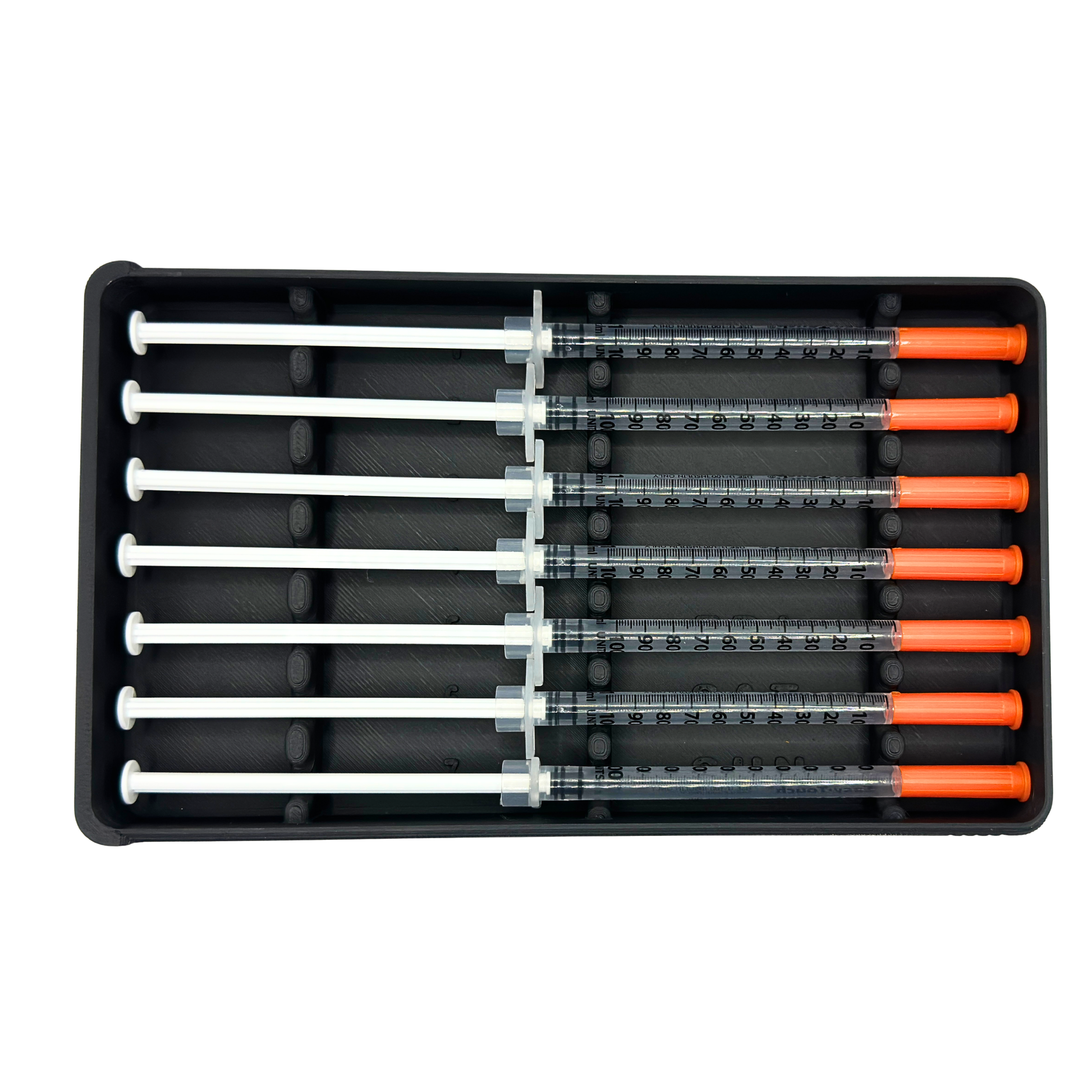 7-slot weekly syringe organizer case shown empty to display interior layout. Numbered slots 1 through 7 with day-of-week labels Monday through Sunday and raised dividers for syringe separation. Black prefilled syringe storage case with sliding lid designed for 1ml insulin syringes up to 180mm long. Ideal for TRT, GLP-1, HRT, or peptide routines.