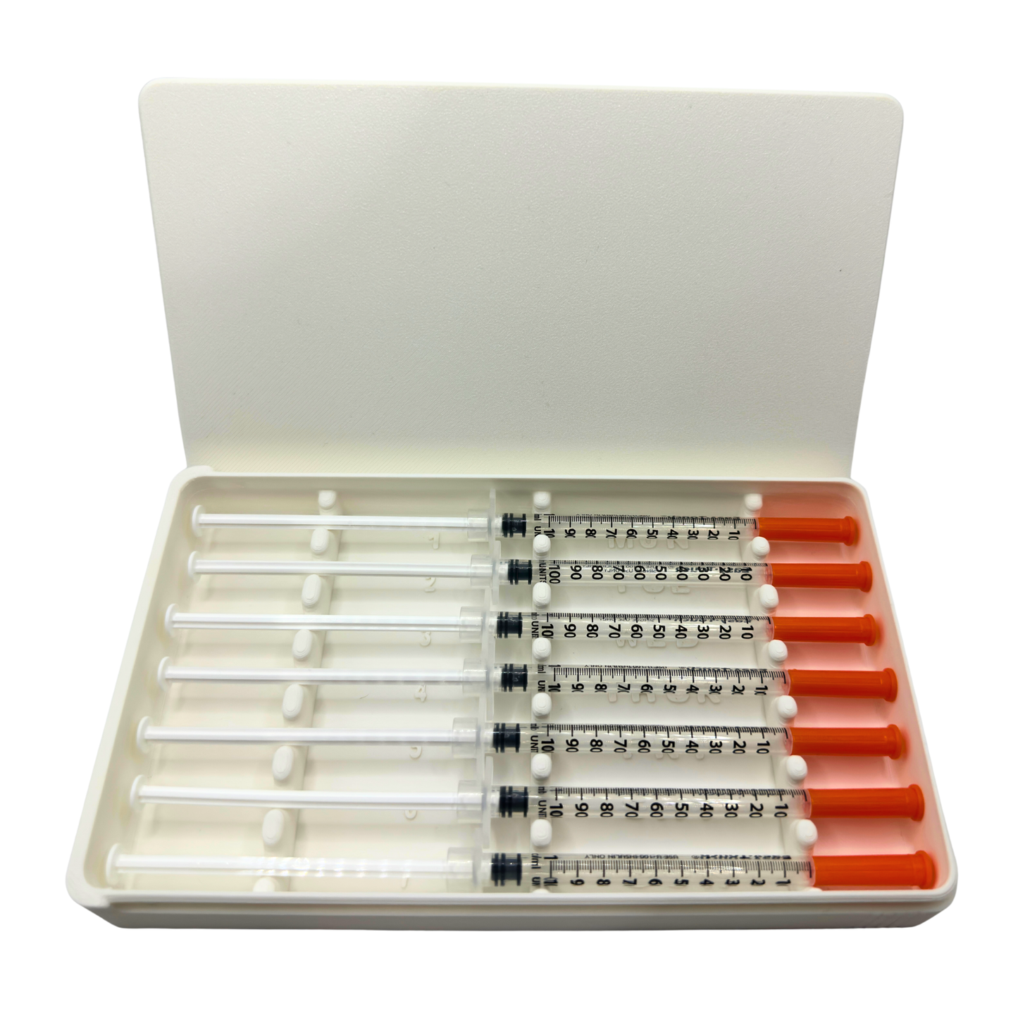 White 7-slot prefilled syringe case open with seven 1ml insulin syringes loaded. Weekly organizer with numbered slots and day-of-week labels Monday through Sunday. Sliding lid syringe holder keeps prefilled doses separated and protected. Compact storage case for TRT, GLP-1, insulin, HRT daily dosing routines.