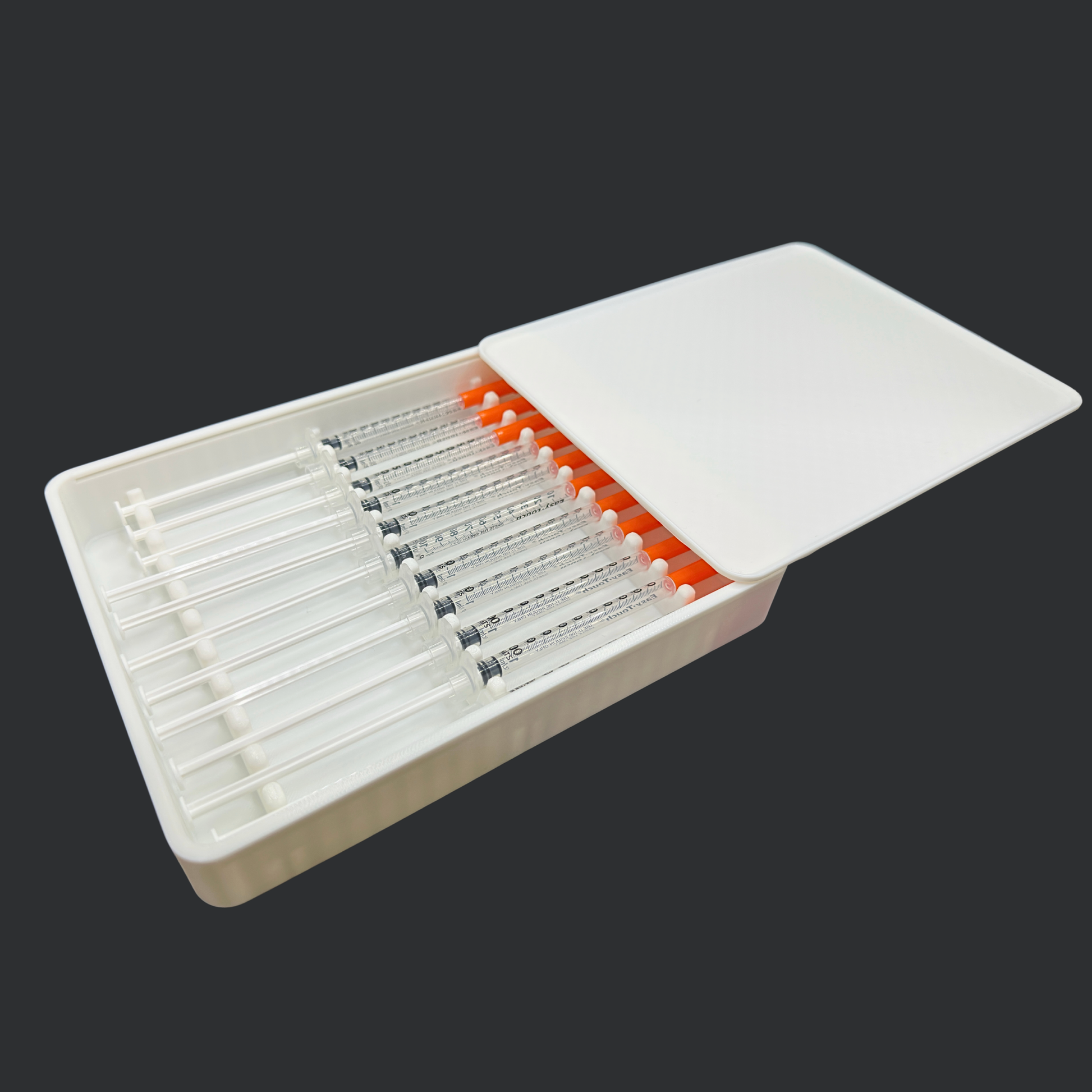 Angled view of 11 slot prefilled syringe storage case with lid partially open showing organized syringe layout. Compact injection organizer designed to hold prefilled 1ml syringes up to 120mm long. Slim profile allows easy fridge, drawer, or travel storage. Ideal for TRT, GLP-1, insulin, and wellness dose preparation. Protective lid keeps syringes covered when closed.
