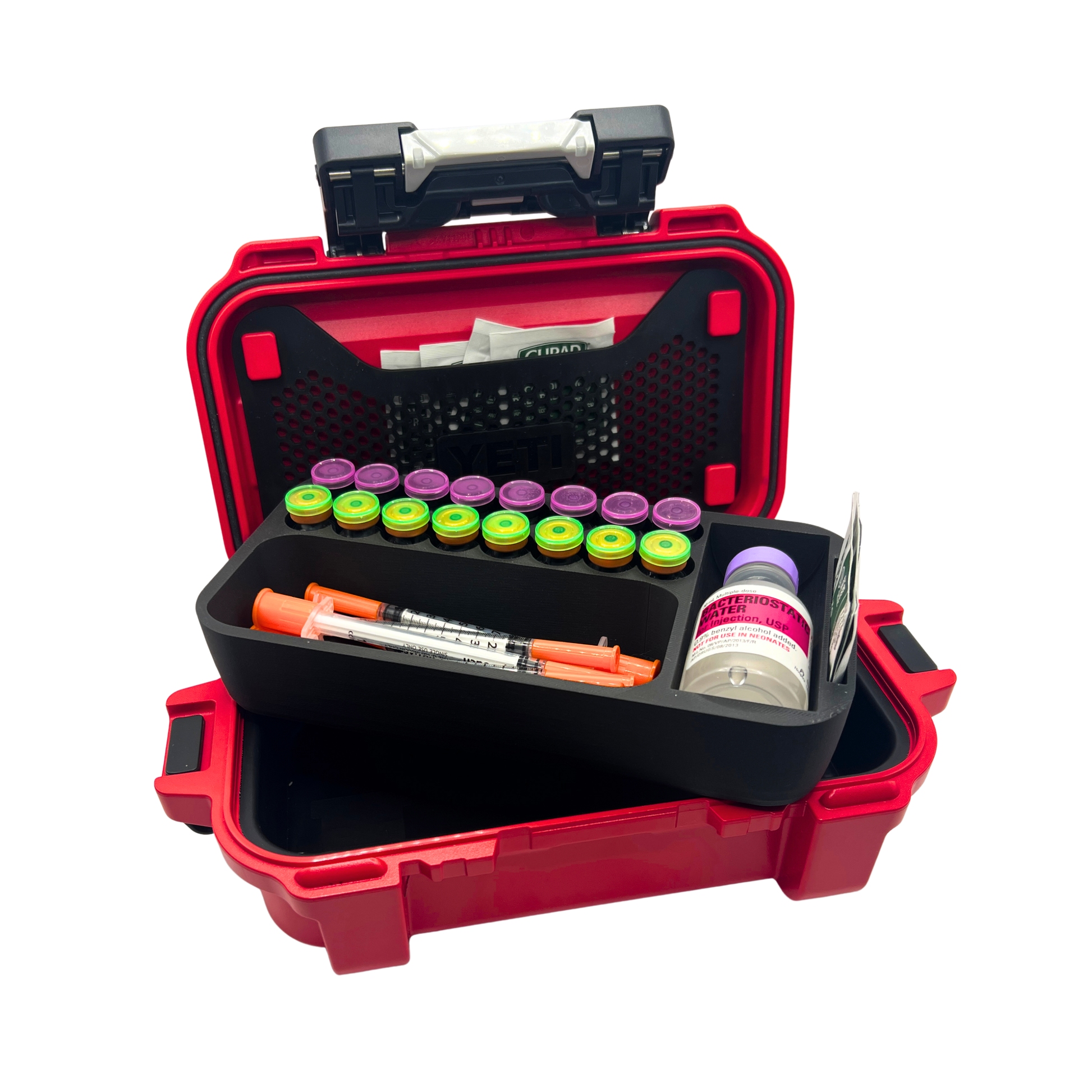 Loaded vial organizer insert lifted out of YETI GoBox 1 showing 16 3ml vials, syringes, and BAC water bottle in compartments